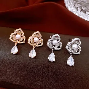 Elegant floral pearl drop earrings in gold and silver finish with zircon pendants