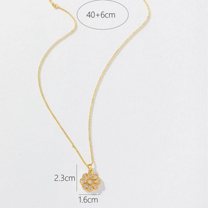 Elegant gold sunflower necklace with sparkling zircon stones on a white background
