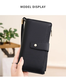 Detail of black RFID women's wallet with lychee texture and wrist strap and snap closure