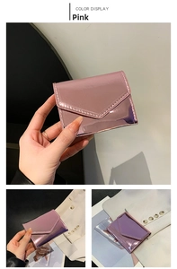 Detailed close-up of glossy pink metallic envelope card wallet with fine stitching