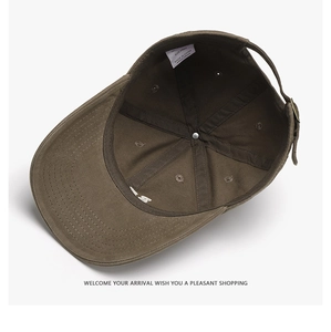 Detail of internal lining, adjustable buckle, and wash label on washed cotton baseball cap
