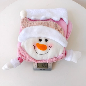 Detailed view of the 133.3g lightweight pink snowman Christmas stocking on a digital scale