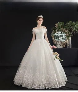 Detail showing off-shoulder bridal gown with sparkling sequins and delicate lace embroidery