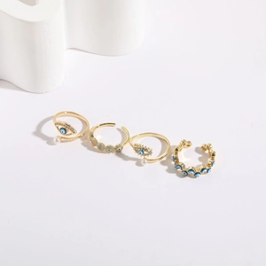 Detailed view of evil eye ring set in 14K gold plating with blue enamel and pearls