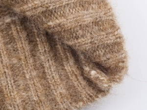 Close-up of soft camel mohair knit fabric showing detailed fluffy texture and ribbing