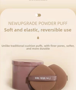 Detail of two coffee-colored cushion puffs with storage case and I'm Milk tea ribbon