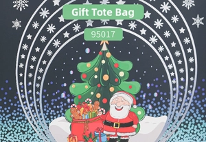 Close-up of Christmas gift bag with Santa and tree illustration on dark blue background
