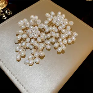 Elegant floral pearl cluster earrings with white teardrop pearls and gold wire design