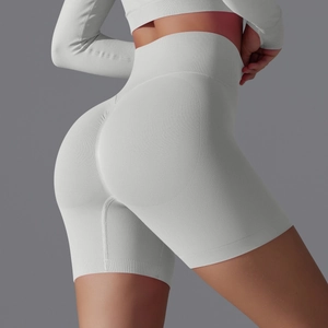 Close-up of high-waisted seamless light gray yoga shorts featuring a peach lift design