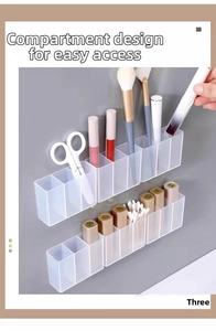 Macro shot of wall-mounted organizer box showing compartments for lipstick and brushes