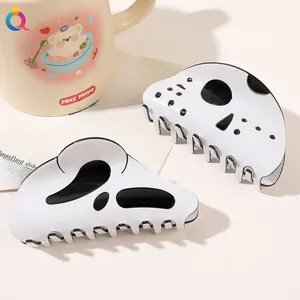Detailed view of Halloween ghost and skull hair claws with polished black and white finish