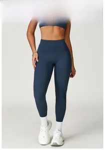 Detail view of high-waist yoga leggings in badge blue with seamless elastic matte fabric