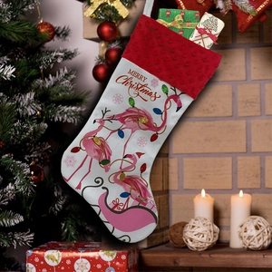 Detail of white Christmas stocking with pink flamingo and Merry Christmas text decor