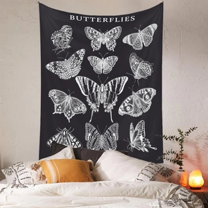 Close-up of vintage butterfly tapestry hanging on wall above bedroom bed with lighting