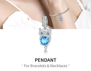 Detail of 925 silver owl charm with large blue zircon inlay for DIY bracelets