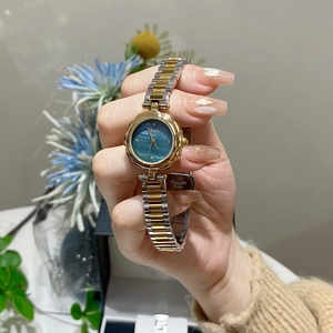 Elegant gold flower bezel watch for women with blue-green dial and stainless steel strap