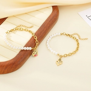 Close-up of gold heart Mom pendant and pearl splicing chain bracelet with elegant silk texture