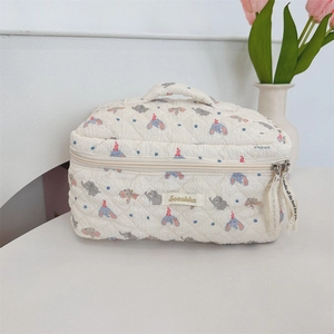 Quilted off-white cosmetic bag with grey elephant pattern and blue polka dots design