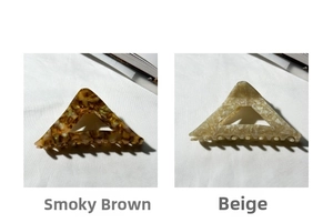 Detail of triangle hair claw clips in tortoise shell and beige marble acrylic patterns