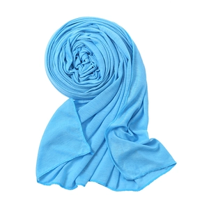 Detail of bright blue knitted cotton scarf showing texture and overlock stitch edges