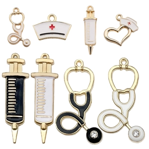 Detail of medical charms including alloy syringes, stethoscopes and nurse hats with enamel