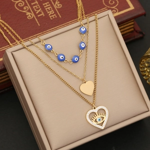 Gold layered stainless steel necklace with blue evil eye beads and heart pendant