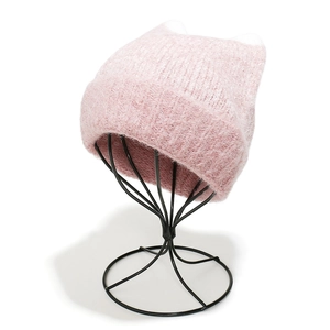 Close-up of pink knitted cat ear hat featuring fluffy mohair texture and ribbed cuff detail
