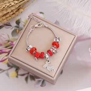 Christmas charm bracelet with red beads and donkey pendant in a beige jewelry gift box