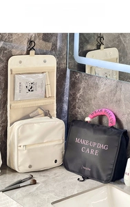 Hanging cosmetic bag with compartments and pearl handle for travel organization