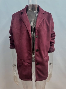 Detail view of burgundy faux suede blazer featuring notched lapels and flap pockets