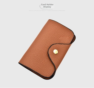 Detail view of brown lychee texture card holder with round golden metal snap button