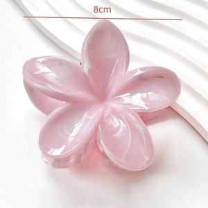 Detail view of 8cm pink marble flower hair claw clip with acetate texture on white background
