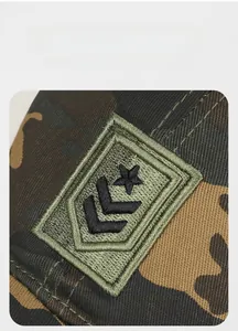 Detailed close-up of high-density star embroidery on camouflaged baseball cap canvas