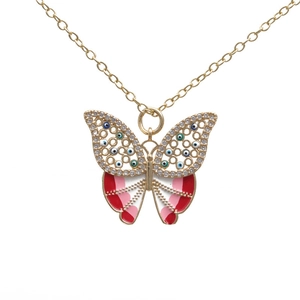 Gold necklace with butterfly pendant featuring evil eye stones and colorful enamel finish