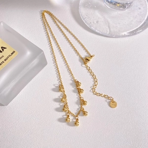 Elegant gold plated stainless steel necklace featuring small round bead sphere pendants