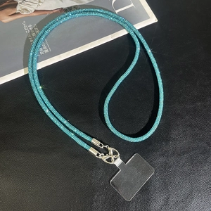 Close-up of luxury lake blue rhinestone phone strap with silver lobster clasp and墊片