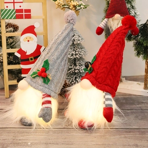 Lighted Christmas gnomes with knitted hats and glowing bases for holiday table decor
