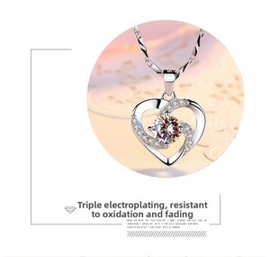 Detail of silver heart pendant with large round zircon and twisted rope chain necklace