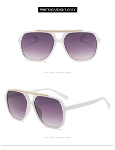 Detail view of white frame aviator sunglasses with gradient purple lenses and gold metal trim