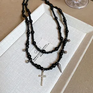 Y2K gothic double-layer black beaded necklace with silver cross pendant on display