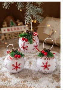 Detail of Christmas plaid balls with pine needles and cones on snowy background