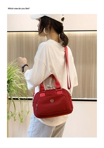 Detailed side view of a vibrant red nylon tote bag with adjustable shoulder strap