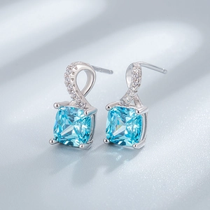 Square cut blue emerald-style S925 sterling silver stud earrings on silk fabric