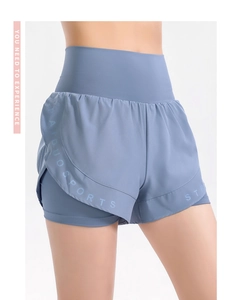 Detailed view of high-waisted grey-blue layered sports shorts with athletic logo print