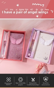 Detail of pink mermaid stationery set featuring sequin notebook with angel wings and glitter pen