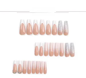 Detail of long coffin press-on nails with French tips, silver glitter, and rhinestones