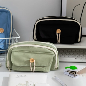 Minimalist high-capacity canvas pencil case with double zippers and wooden button detail