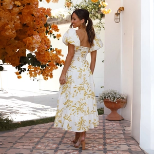 Detailed back view of white floral tiered maxi dress with puff sleeves and square neckline