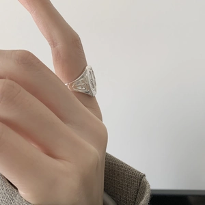 Close-up of S925 sterling silver signet ring with cross relief on a finger
