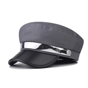 Grey newsboy cap with black leather brim and silver M metal buckle accent